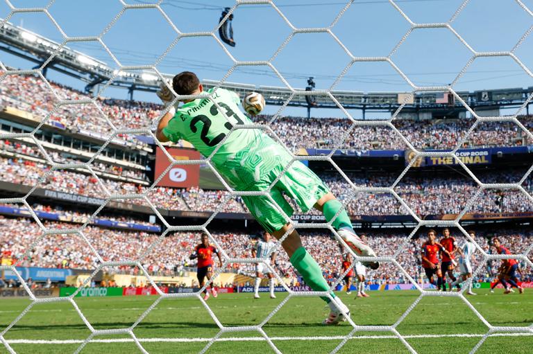 EAST RUTHERFORD, NEW JERSEY - JULY 19: (EDITOR'S NOTE: Image was captured using a remote camera from behind the goal.) Emiliano Martinez #23 of Argentina makes a save during the FIFA World Cup 2026 Final match between Spain and Argentina at New York New Jersey Stadium on July 19, 2026 in East Rutherford, New Jersey. (Photo by Hannah Peters - FIFA/FIFA via Getty Images)